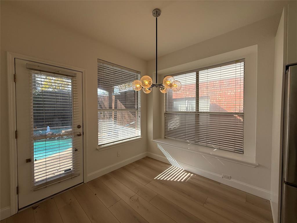 2254 Ash Grove Way Dallas, TX 75228 - Photo 20 of 23 a view of an empty room with a window and wooden floor