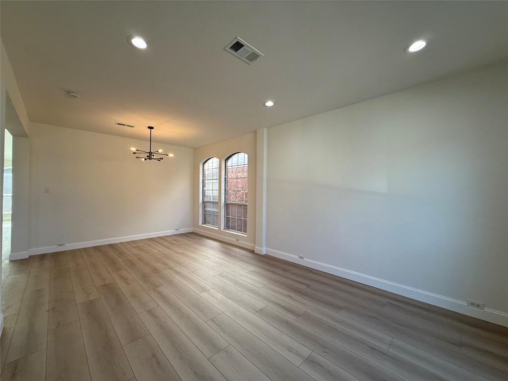 2254 Ash Grove Way Dallas, TX 75228 - Photo 22 of 23 an empty room with wooden floor and windows