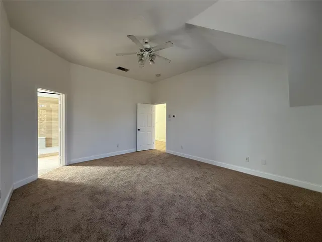 an empty room with a empty space and a ceiling fan