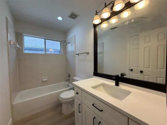 a bathroom with a sink a toilet and a bathtub