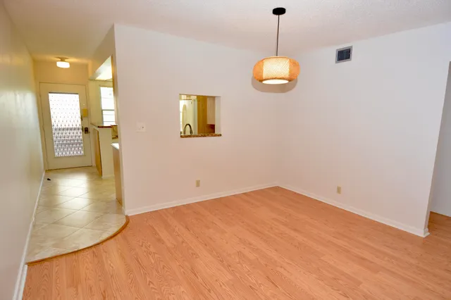 a view of a room with wooden floor and windows