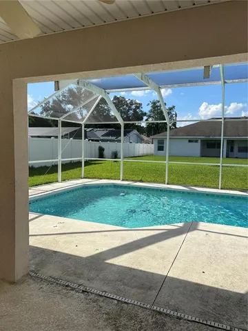 a view of a swimming pool with an outdoor space and seating area