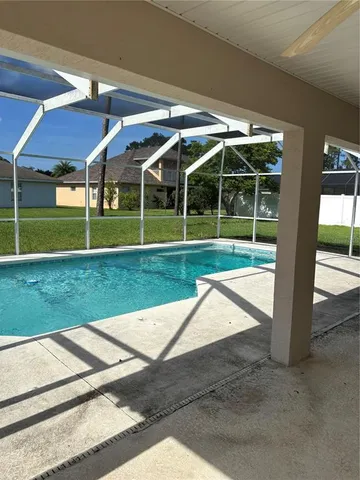 a view of a house with backyard and porch