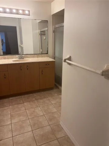 a bathroom with a sink a mirror and a shower