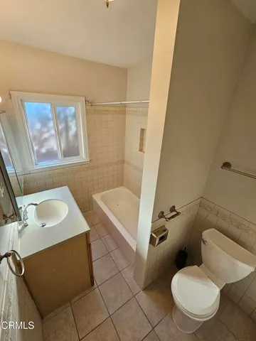 a bathroom with a sink vanity and tub