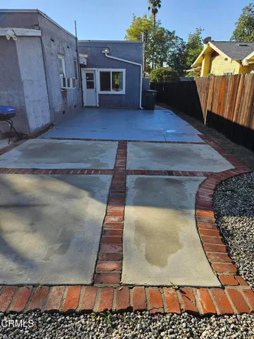 a backyard of a house with table and chairs