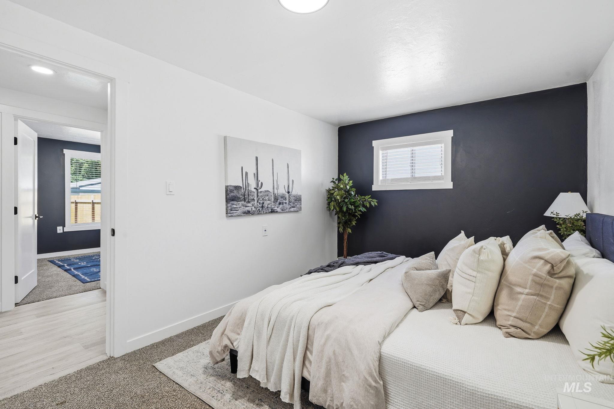 2152 Artesian Road Eagle, ID 83616 - Photo 22 of 50 Room featuring a striking accent wall, a white window with blinds, and white trim
