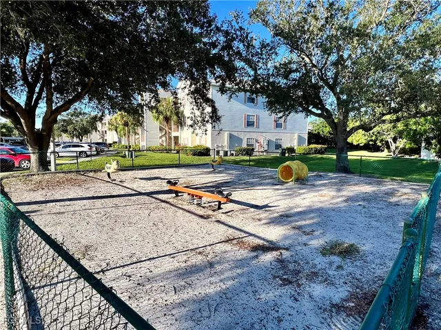 a view of a backyard with a garden and trees