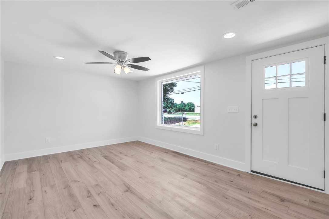 7 Beaverdam Road Williamston, SC 29697 - Photo 9 of 27 A welcoming entry space with light-toned hardwood flooring and a classic paneled door.