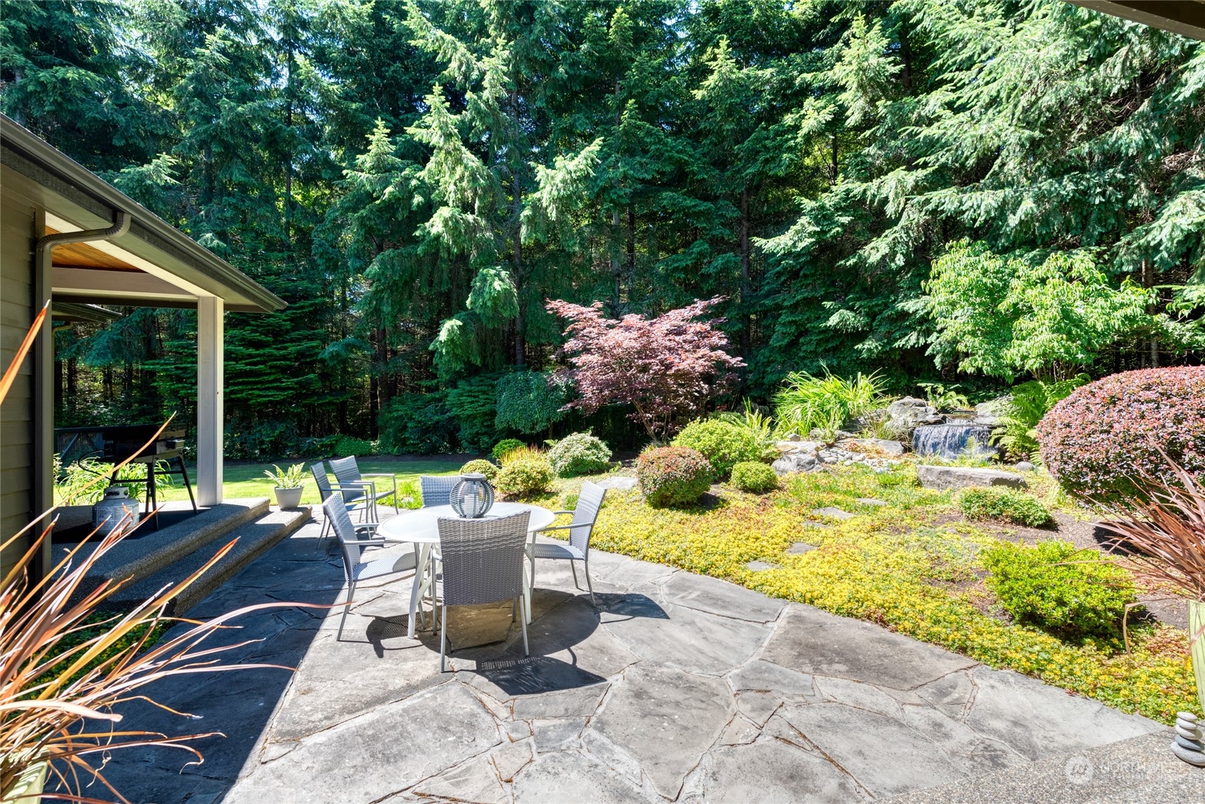 4635 D D Milluhr Road Northeast Olympia, WA 98516 - Photo 21 of 40 a view of a patio with table and chairs and potted plants