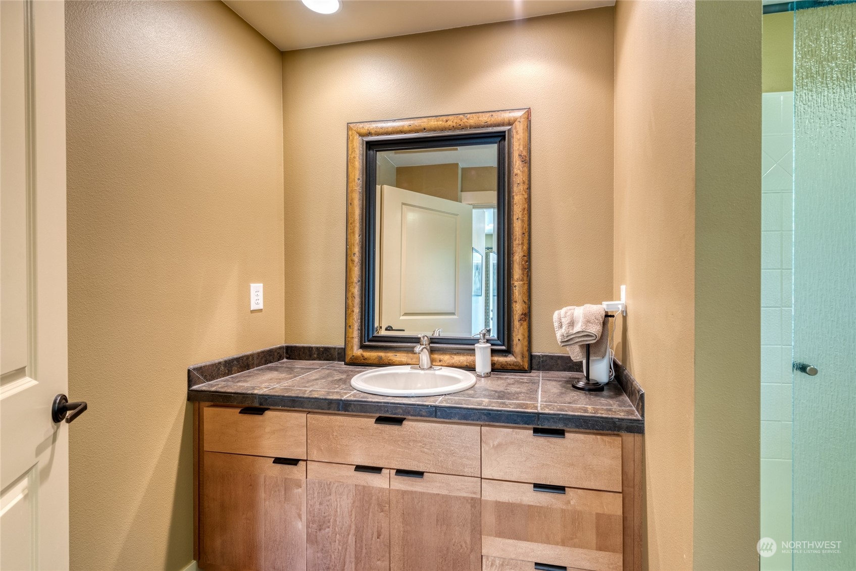 4635 D D Milluhr Road Northeast Olympia, WA 98516 - Photo 27 of 40 a bathroom with a granite countertop sink and a mirror