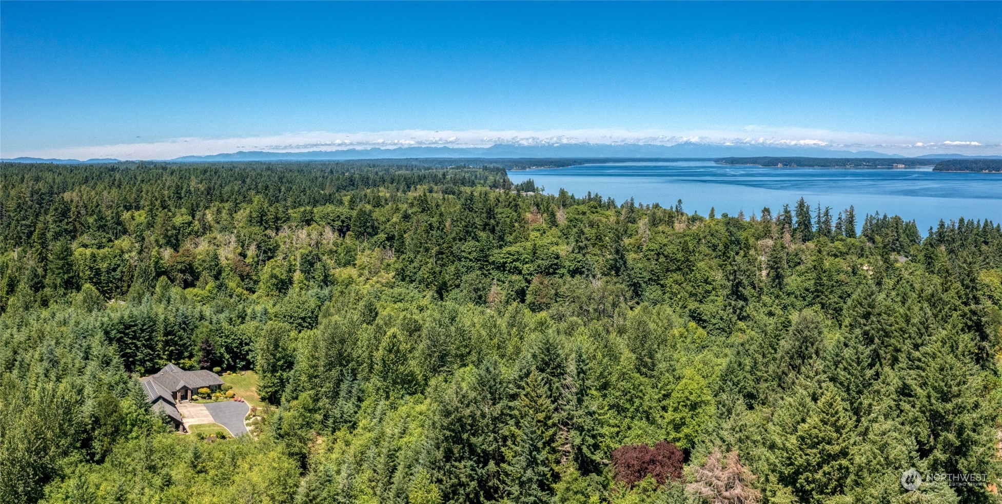 4635 D D Milluhr Road Northeast Olympia, WA 98516 - Photo 37 of 40 a view of a room with floor to ceiling fan and wooden floor