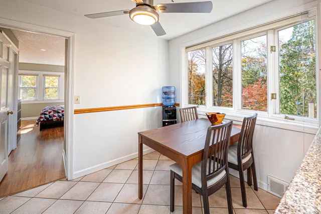 a dining room with furniture and wooden floor