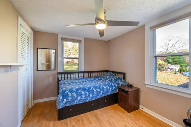 a bed sitting in a bedroom next to a window