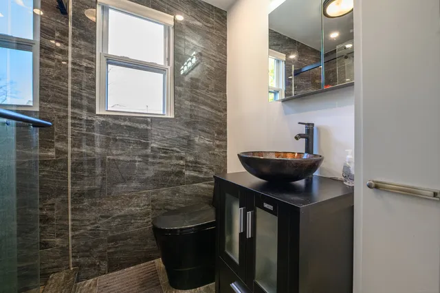 a bathroom with a sink a toilet and a window