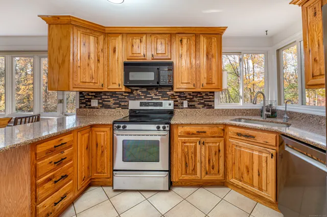 a kitchen with stainless steel appliances granite countertop a sink stove and microwave