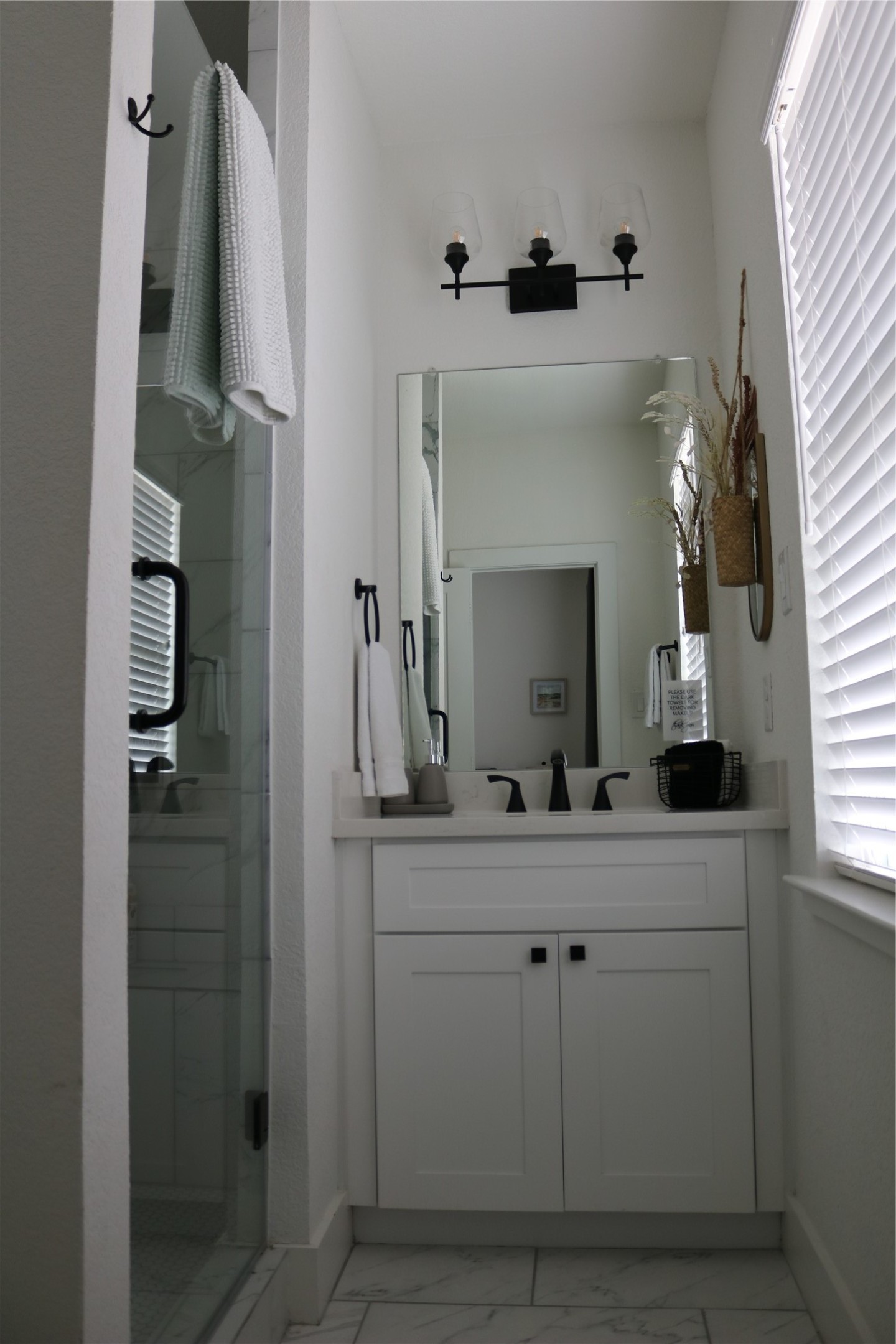 4714 Fisk Street Houston, TX 77009 - Photo 20 of 20 a bathroom with a double vanity sink and mirror