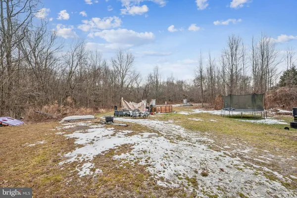 a view of a yard with snow on the road