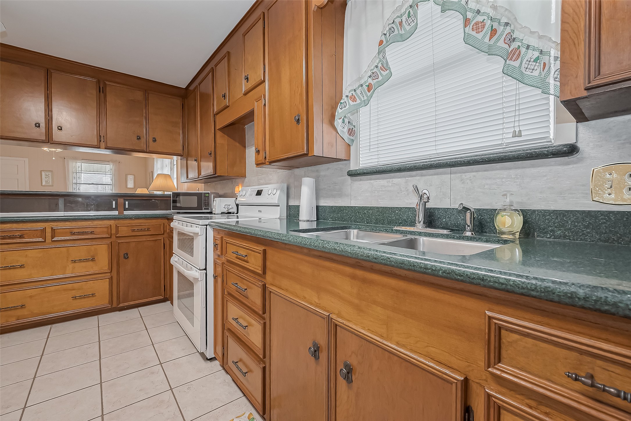 9214 Church Street Needville, TX 77461 - Photo 15 of 44 a kitchen with stainless steel appliances granite countertop a sink and cabinets