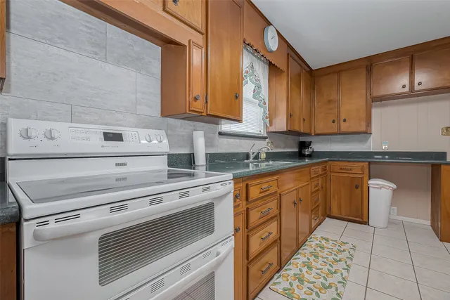 a kitchen with stainless steel appliances granite countertop a sink and cabinets