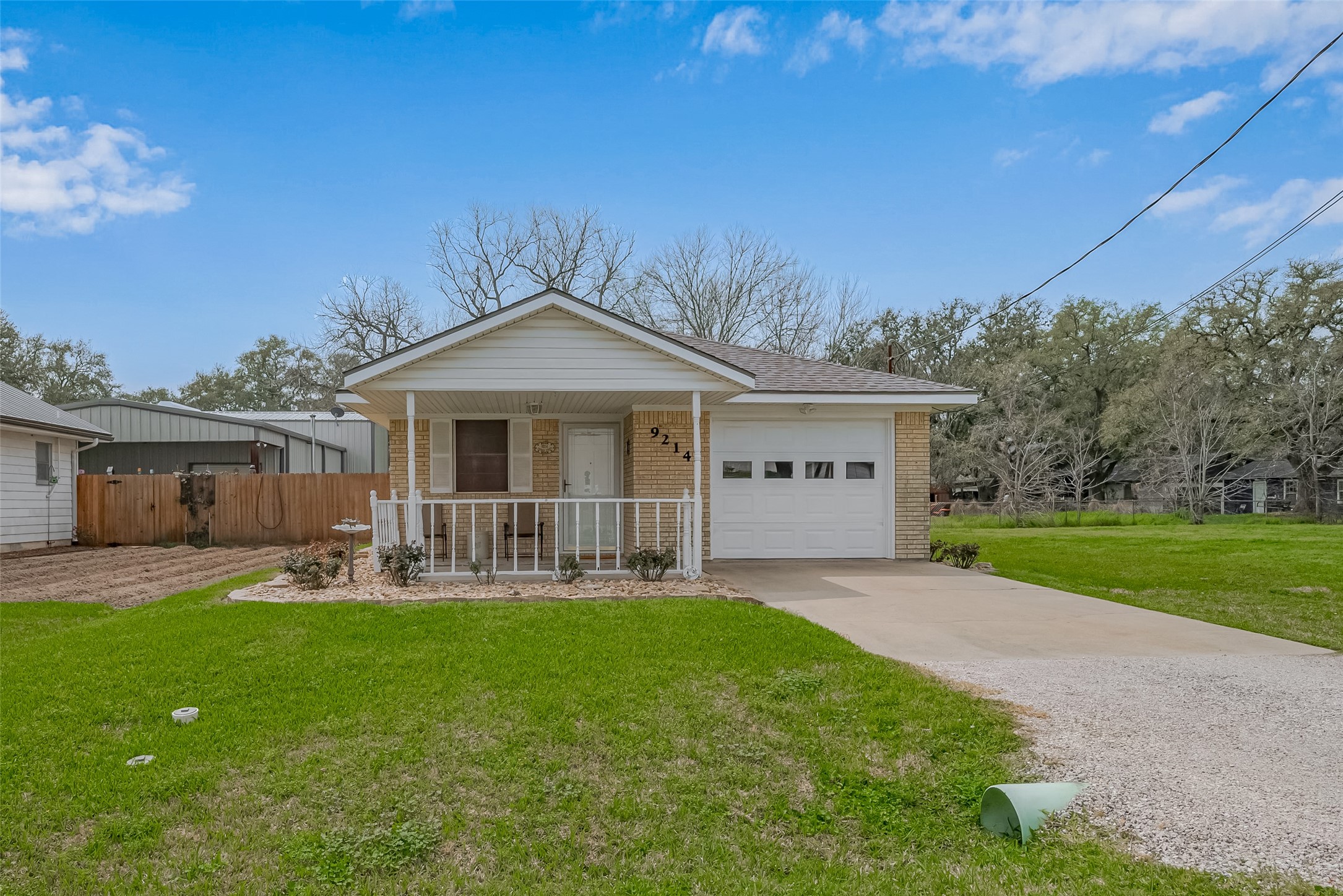 9214 Church Street Needville, TX 77461 - Photo 2 of 44 a front view of house with a garden and yard