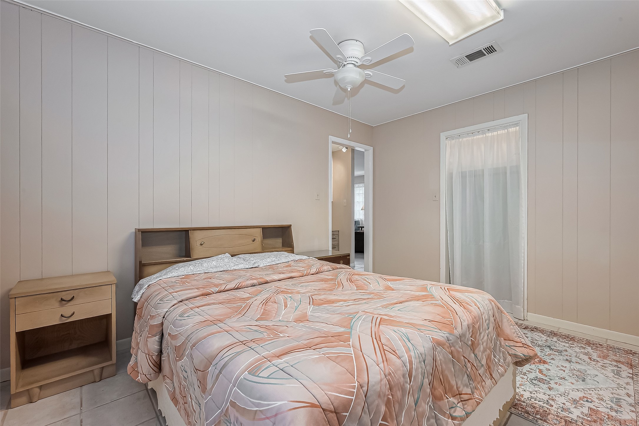 9214 Church Street Needville, TX 77461 - Photo 27 of 44 a bedroom with a bed and a chandelier