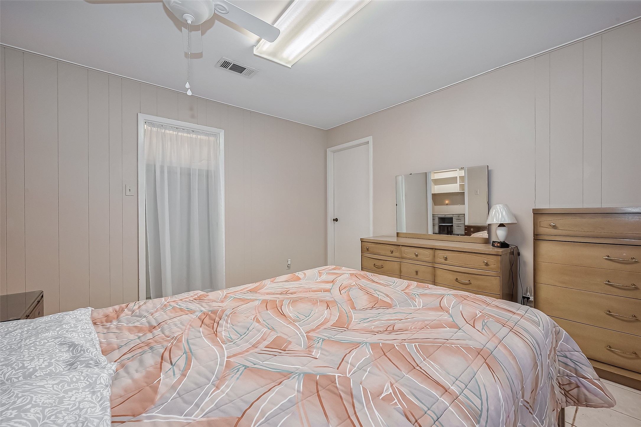 9214 Church Street Needville, TX 77461 - Photo 28 of 44 a bedroom with a large bed and a chandelier