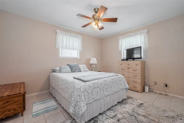 a bedroom with a bed and a tv