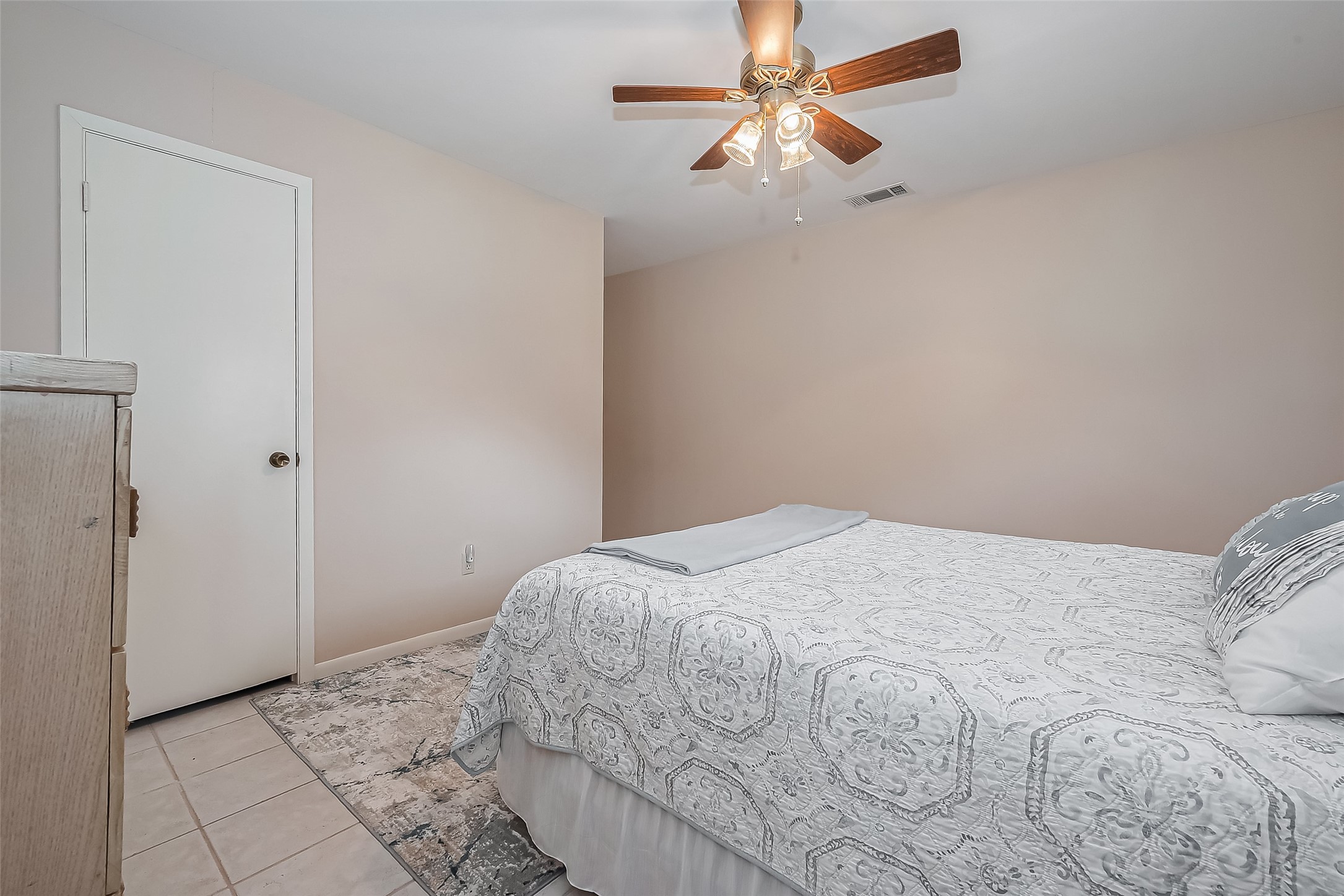 9214 Church Street Needville, TX 77461 - Photo 31 of 44 a bedroom with a bed and a chandelier