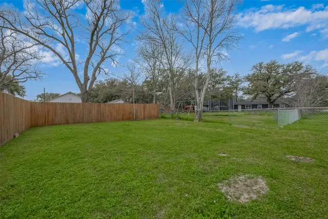 a view of a yard with a tree