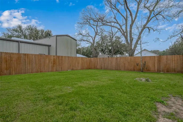 a view of a backyard with large tree