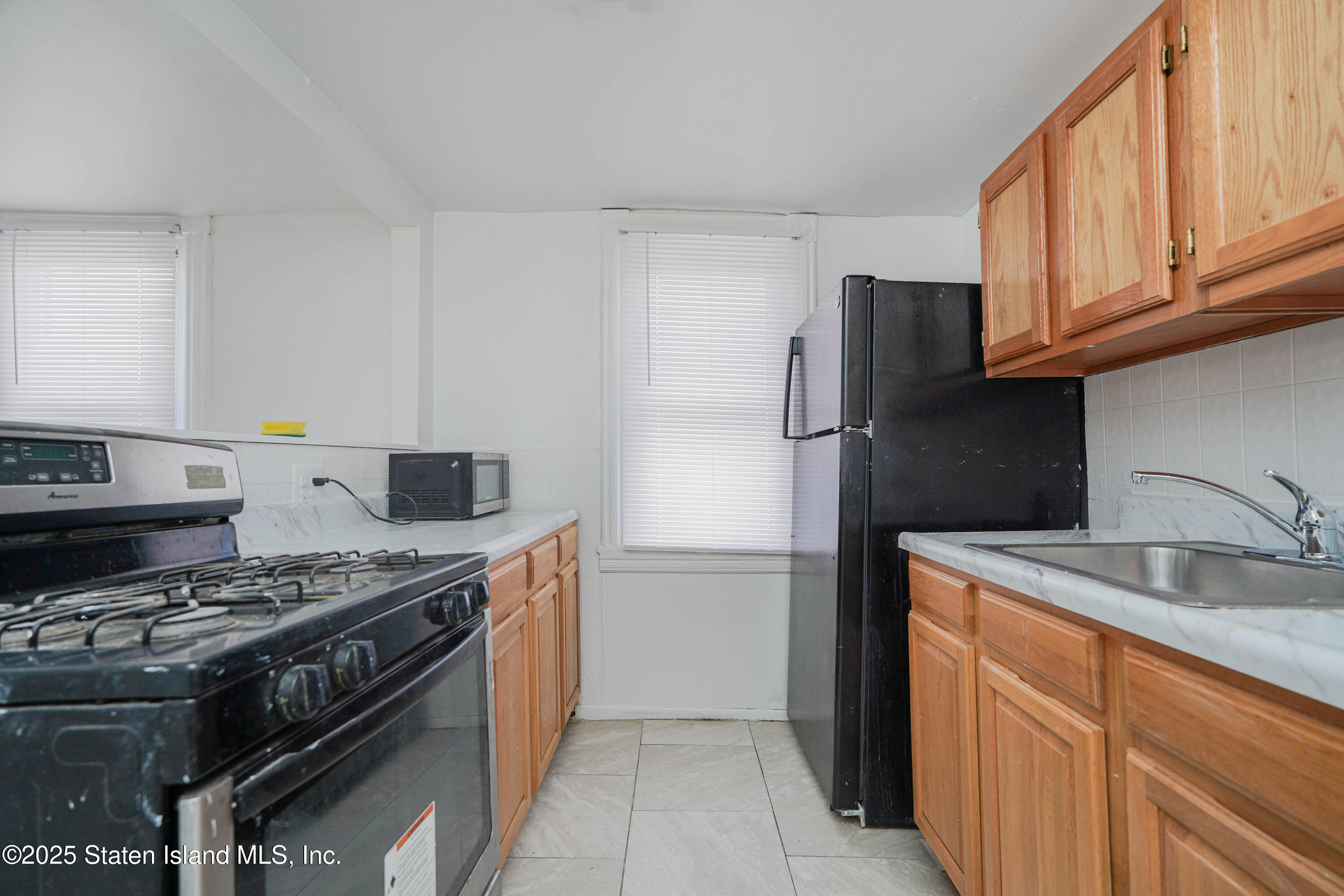 40 Larkin Street Staten Island, NY 10302 - Photo 15 of 36 a kitchen with stainless steel appliances granite countertop a stove and a refrigerator