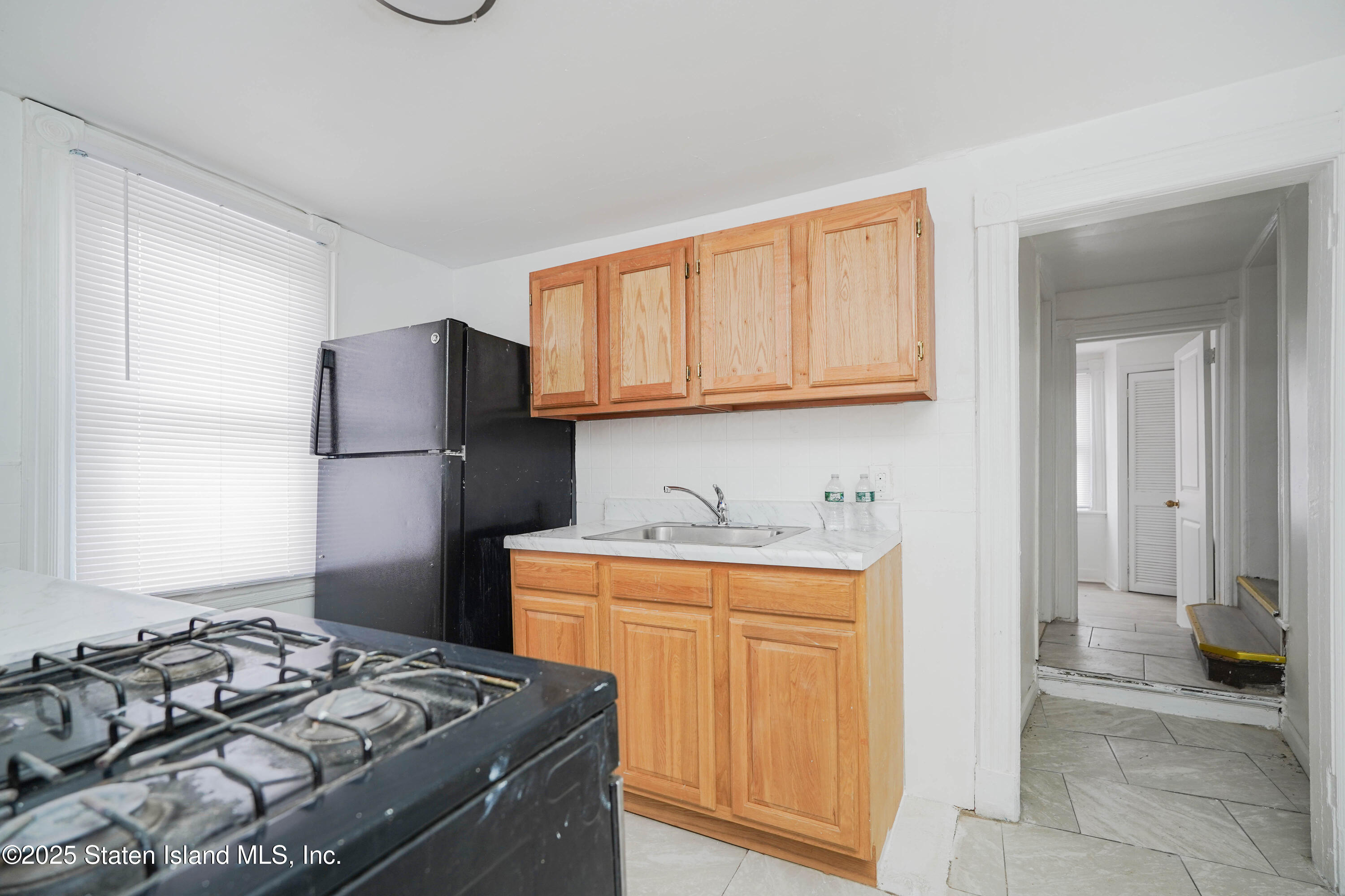 40 Larkin Street Staten Island, NY 10302 - Photo 18 of 36 a kitchen with a stove and a refrigerator
