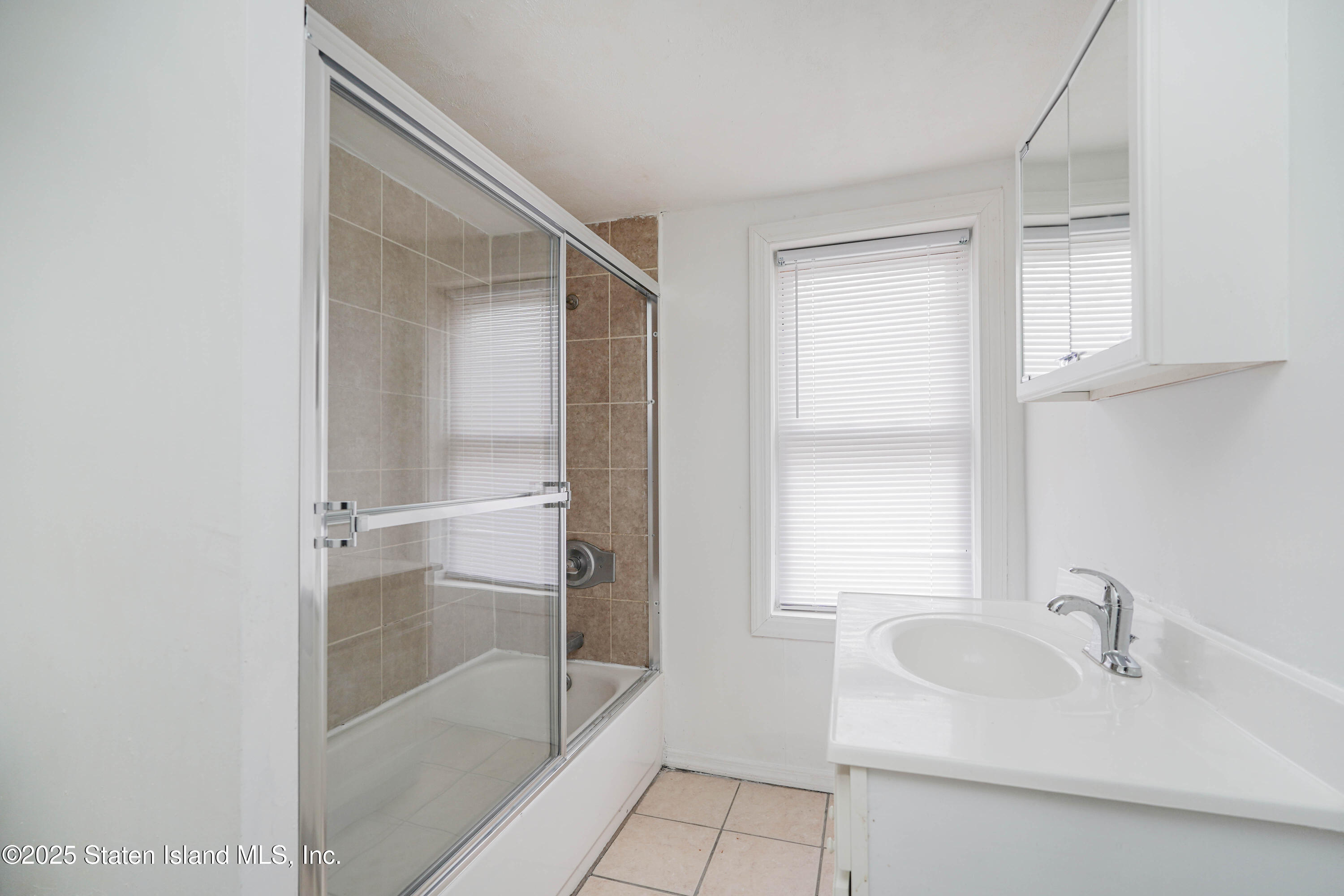 40 Larkin Street Staten Island, NY 10302 - Photo 19 of 36 a bathroom with a sink and a mirror