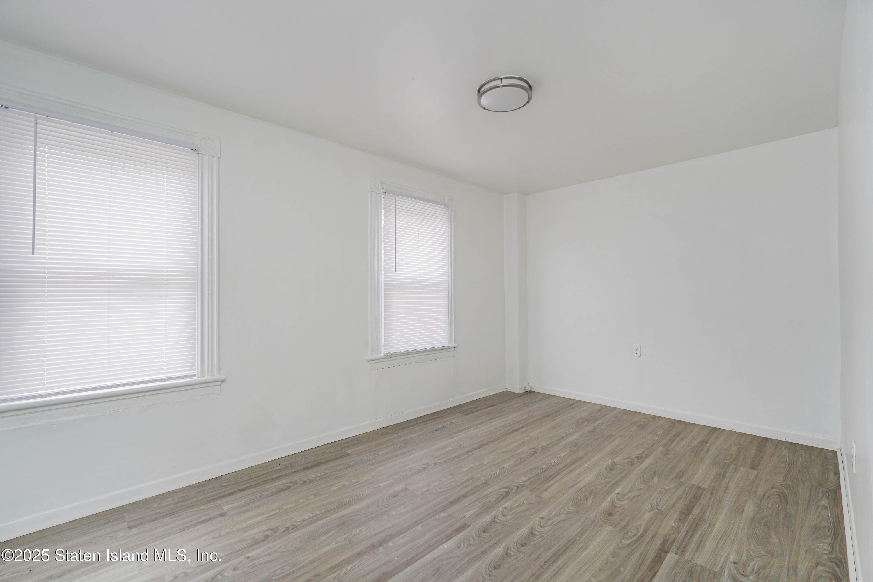 40 Larkin Street Staten Island, NY 10302 - Photo 22 of 36 an empty room with wooden floor and windows