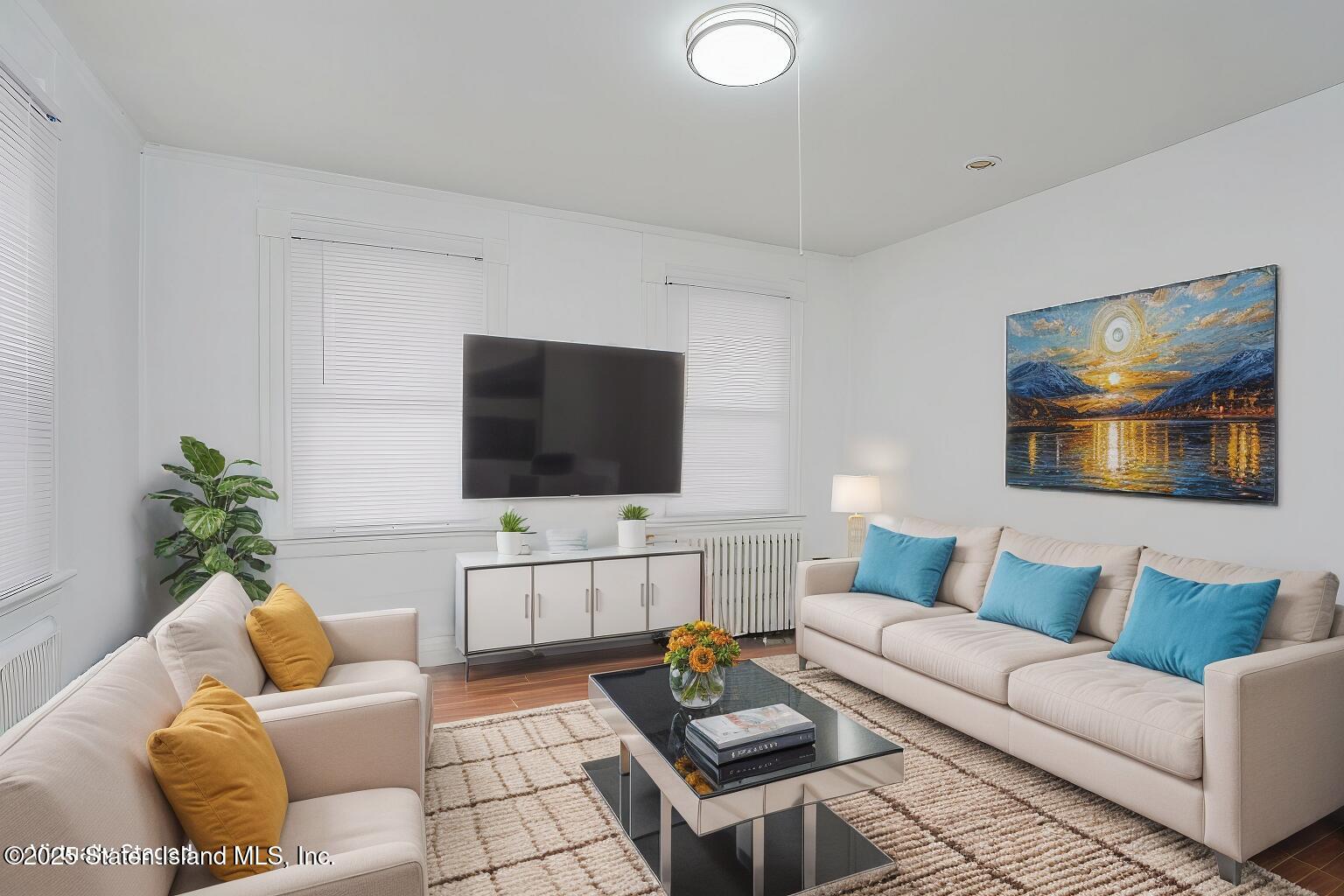40 Larkin Street Staten Island, NY 10302 - Photo 27 of 36 a living room with furniture and a flat screen tv