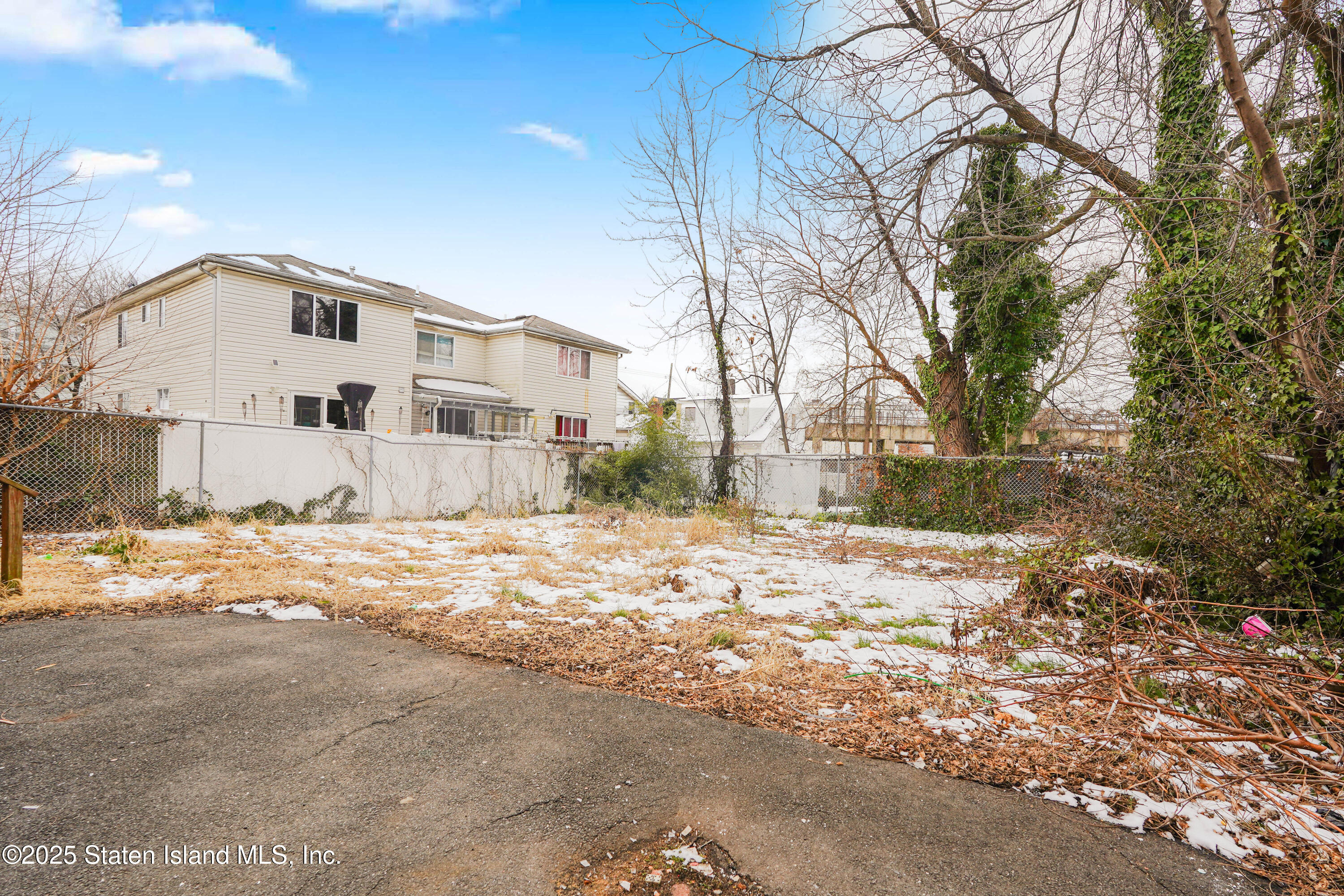 40 Larkin Street Staten Island, NY 10302 - Photo 3 of 36 a view of a large house with a yard covered in snow