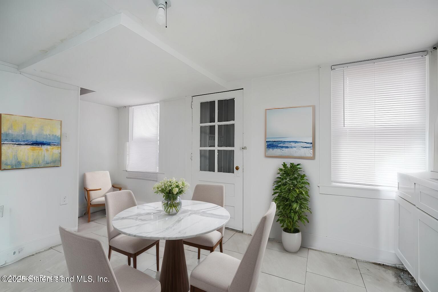 40 Larkin Street Staten Island, NY 10302 - Photo 34 of 36 a view of a dining room with furniture and a potted plant