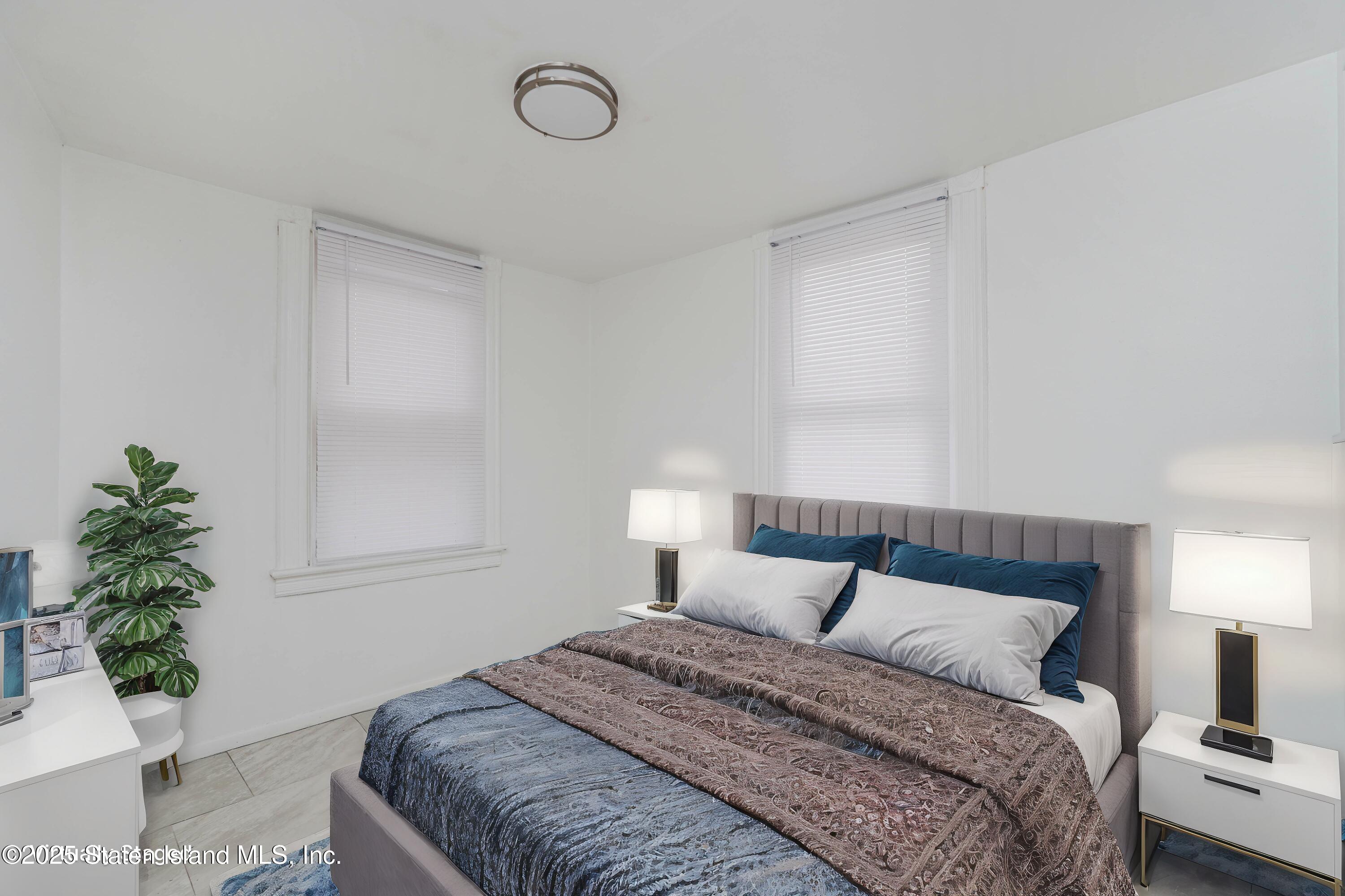 40 Larkin Street Staten Island, NY 10302 - Photo 35 of 36 a bedroom with a bed and a potted plant