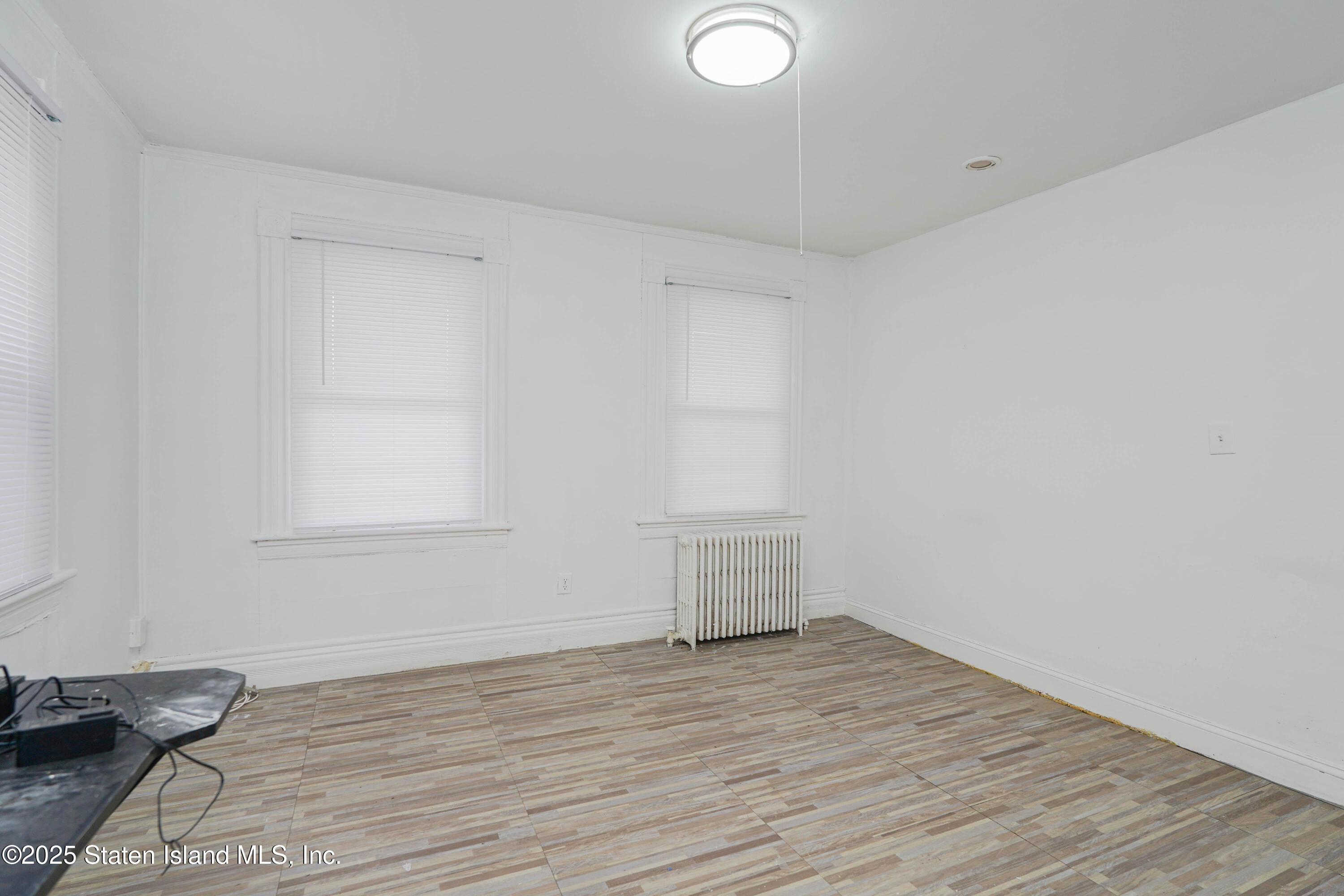 40 Larkin Street Staten Island, NY 10302 - Photo 7 of 36 a view of empty room with wooden floor and fan