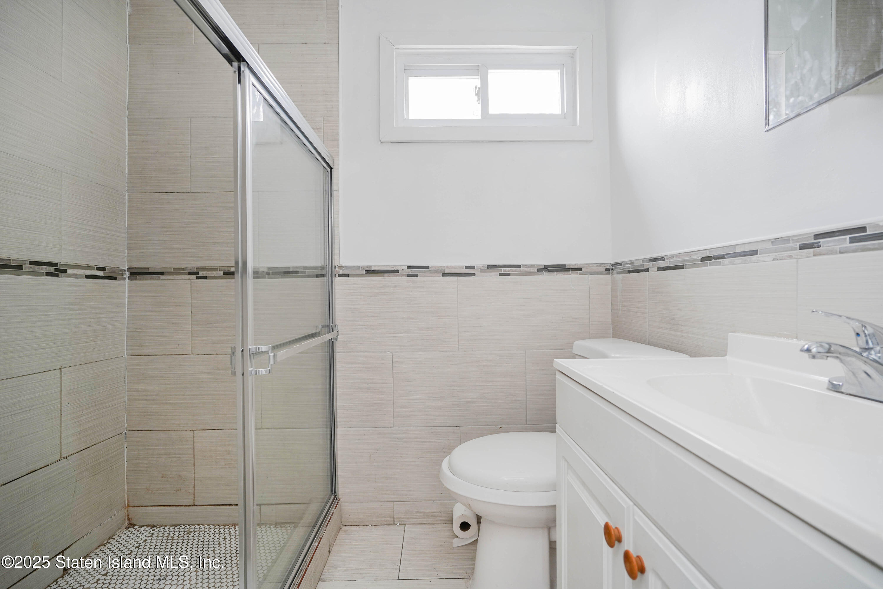 40 Larkin Street Staten Island, NY 10302 - Photo 10 of 36 a bathroom with a toilet and a shower