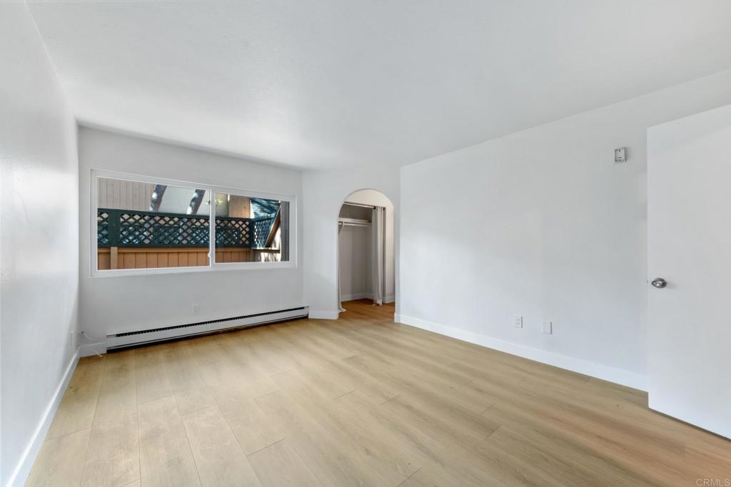 8717 Navajo Road, Unit 1 San Diego, CA 92119 - Photo 15 of 25 an empty room with wooden floor and windows