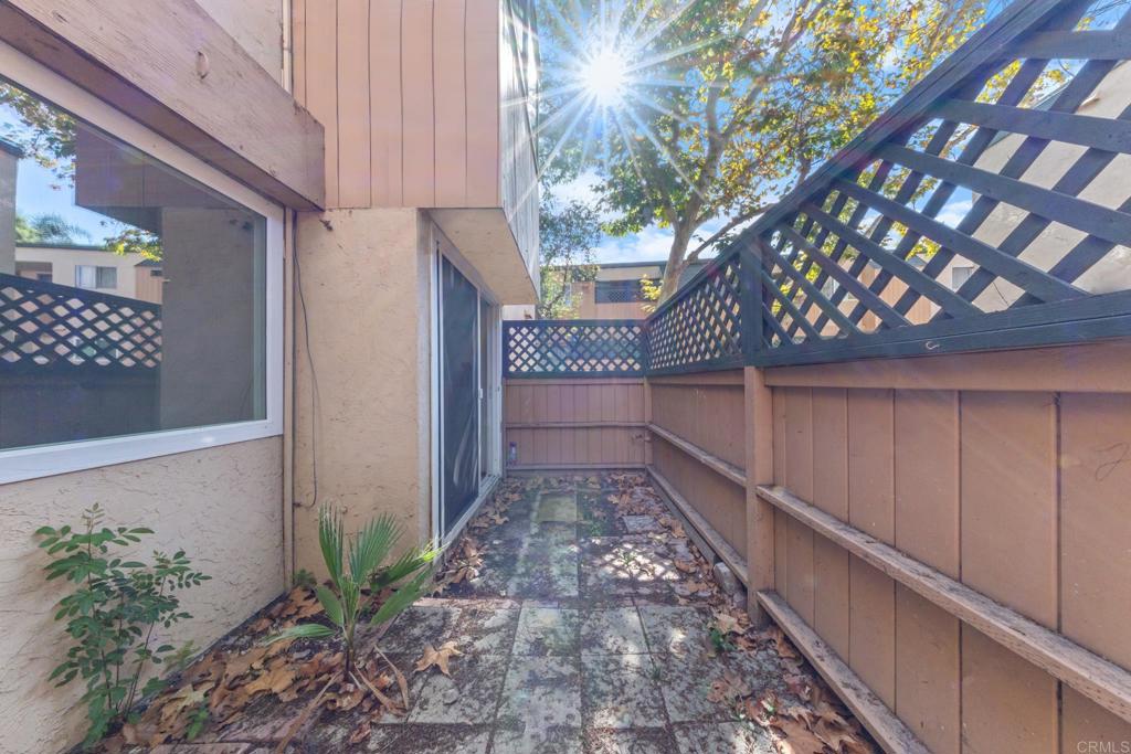 8717 Navajo Road, Unit 1 San Diego, CA 92119 - Photo 8 of 25 a view of a pathway of a house with wooden floor and fence