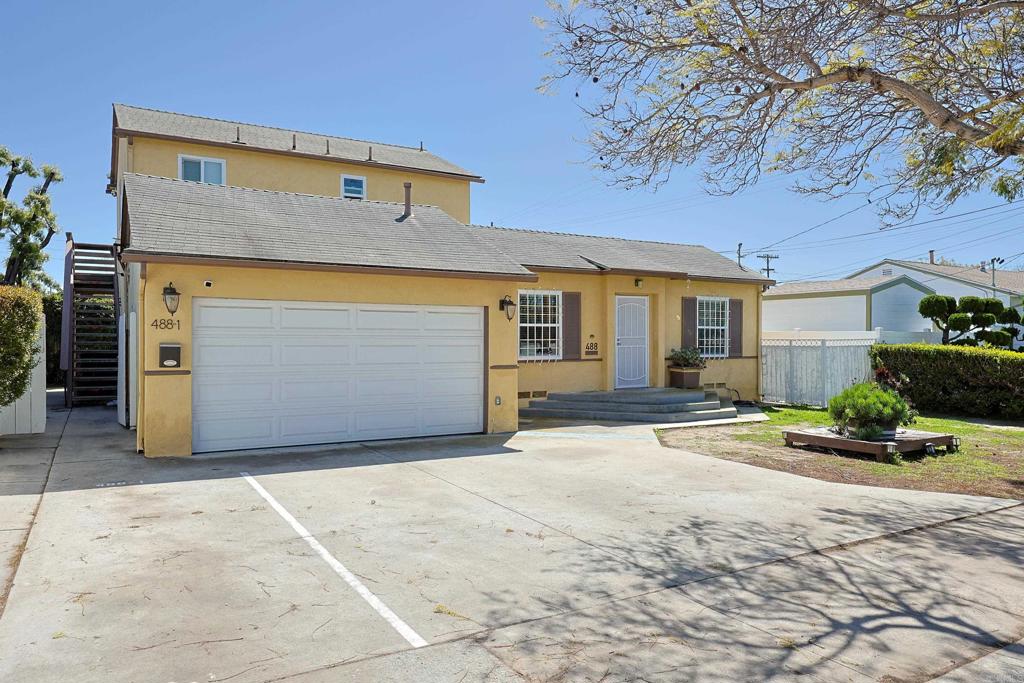 488 D Street Chula Vista, CA 91910 - Photo 2 of 25 a front view of a house with a yard and garage