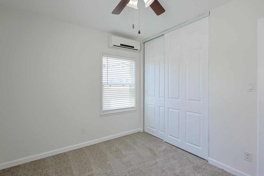 488 D Street Chula Vista, CA 91910 - Photo 22 of 25 an empty room with chandelier fan and windows