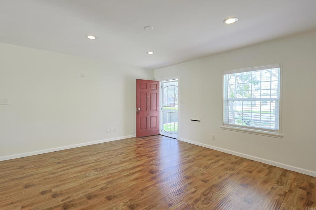 488 D Street Chula Vista, CA 91910 - Photo 3 of 25 an empty room with wooden floor and windows