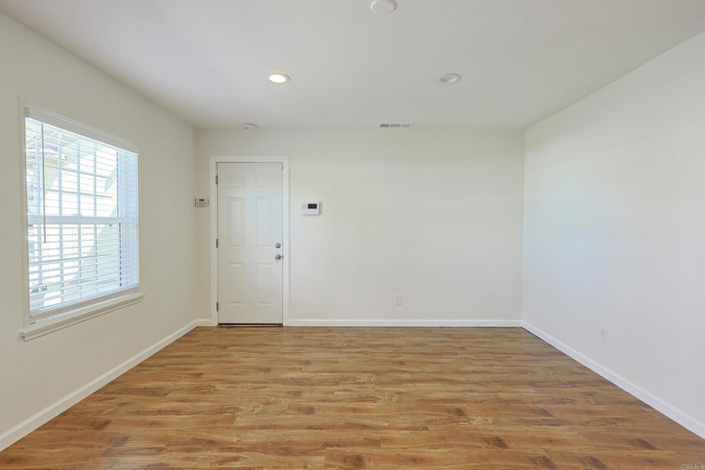 488 D Street Chula Vista, CA 91910 - Photo 4 of 25 a view of an empty room with wooden floor and a window