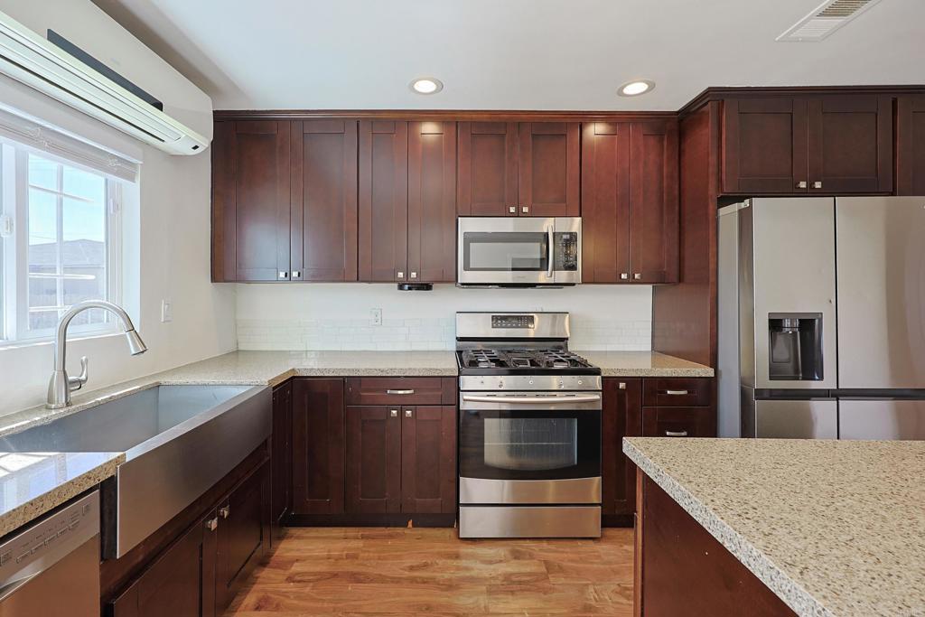 488 D Street Chula Vista, CA 91910 - Photo 6 of 25 a kitchen with a sink stove and refrigerator