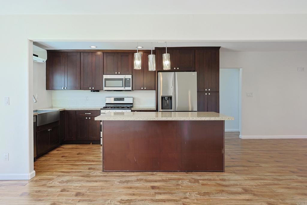 488 D Street Chula Vista, CA 91910 - Photo 7 of 25 a kitchen with wooden cabinets and a sink