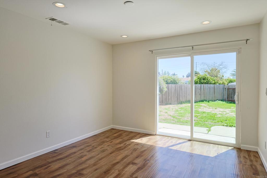 488 D Street Chula Vista, CA 91910 - Photo 9 of 25 a view of an empty room with wooden floor and a window